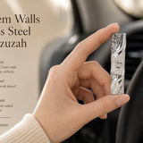 Jerusalem Walls Stainless Steel Car Mezuzah, a silver Israeli travel Judaica piece featuring raised Old City of Jerusalem wall relief, a polished diagonal band, and a raised Shin for Shaddai