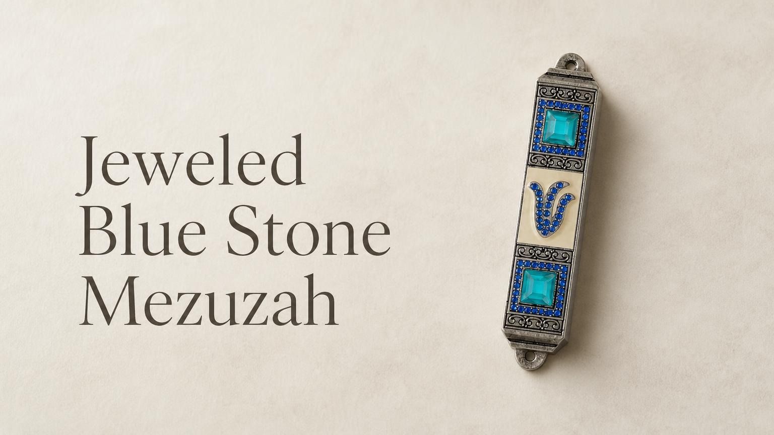Jeweled Blue Stone pewter mezuzah case mounted on a light wall, featuring an antique silver-tone finish, bright turquoise square stones, rows of blue crystals, ornate detailing, and a jeweled Hebrew Shin. This decorative blue Jewish mezuzah case adds rich color and traditional Judaica style to a home doorway