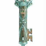 Ornate brown enamel pewter mezuzah in key shape, displayed on a white studio background with soft reflection, detailed craftsmanship.