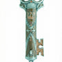 Ornate brown enamel pewter mezuzah in key shape, displayed on a white studio background with soft reflection, detailed craftsmanship.