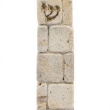 Jerusalem stone Mezuzah modeled after the Kotel with gold Shin, handcrafted in Israel with natural stone texture and unique surface features.