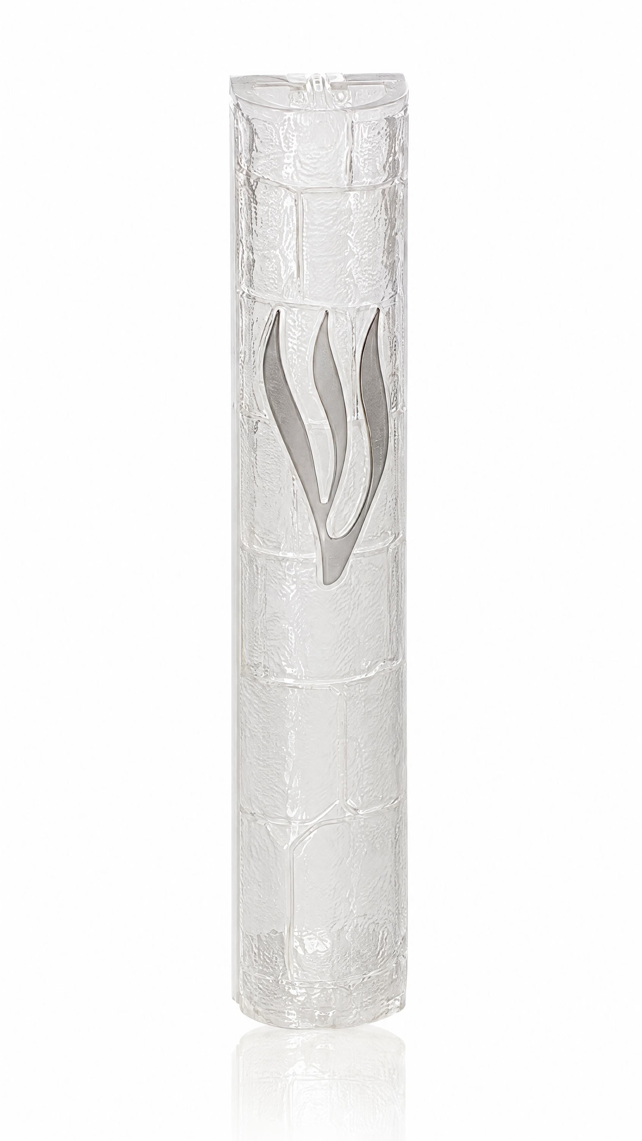 Kotel Stonework Clear Silver Shin Mezuzah mezuzah cover viewed at an angle, showing its long silver-colored Hebrew Shin across a pale translucent plastic stone-block face, with the curved side and lower closure revealing the shape of the Jerusalem-inspired design