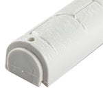 Close view of the bottom closure on the Kotel Stonework Clear Silver Shin mezuzah cover, showing the pale rounded plastic cap, nearby fixing hole and molded stone-block texture around the scroll-insertion end of the case