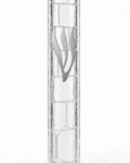 Kotel Stonework Clear Silver Shin Mezuzah shown from the front as a mezuzah cover featuring a clear plastic body, molded stone-block texture and an elongated silver-colored Hebrew Shin above the rounded bottom closure, presenting a detailed Judaica design for a Jewish home doorway