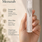 Handheld close view of the Kotel Stonework Clear Silver Shin Mezuzah mezuzah cover, with its long silver-colored Hebrew Shin, pale translucent plastic stone-block surface and cylindrical front shown beside design callouts for this Jerusalem-inspired Judaica piece
