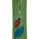 Elegant Ladybug glass mezuzah with intricate Hebrew engravings, shown on a white studio background with soft reflection.