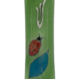 Elegant Ladybug glass mezuzah with intricate Hebrew engravings, shown on a white studio background with soft reflection.