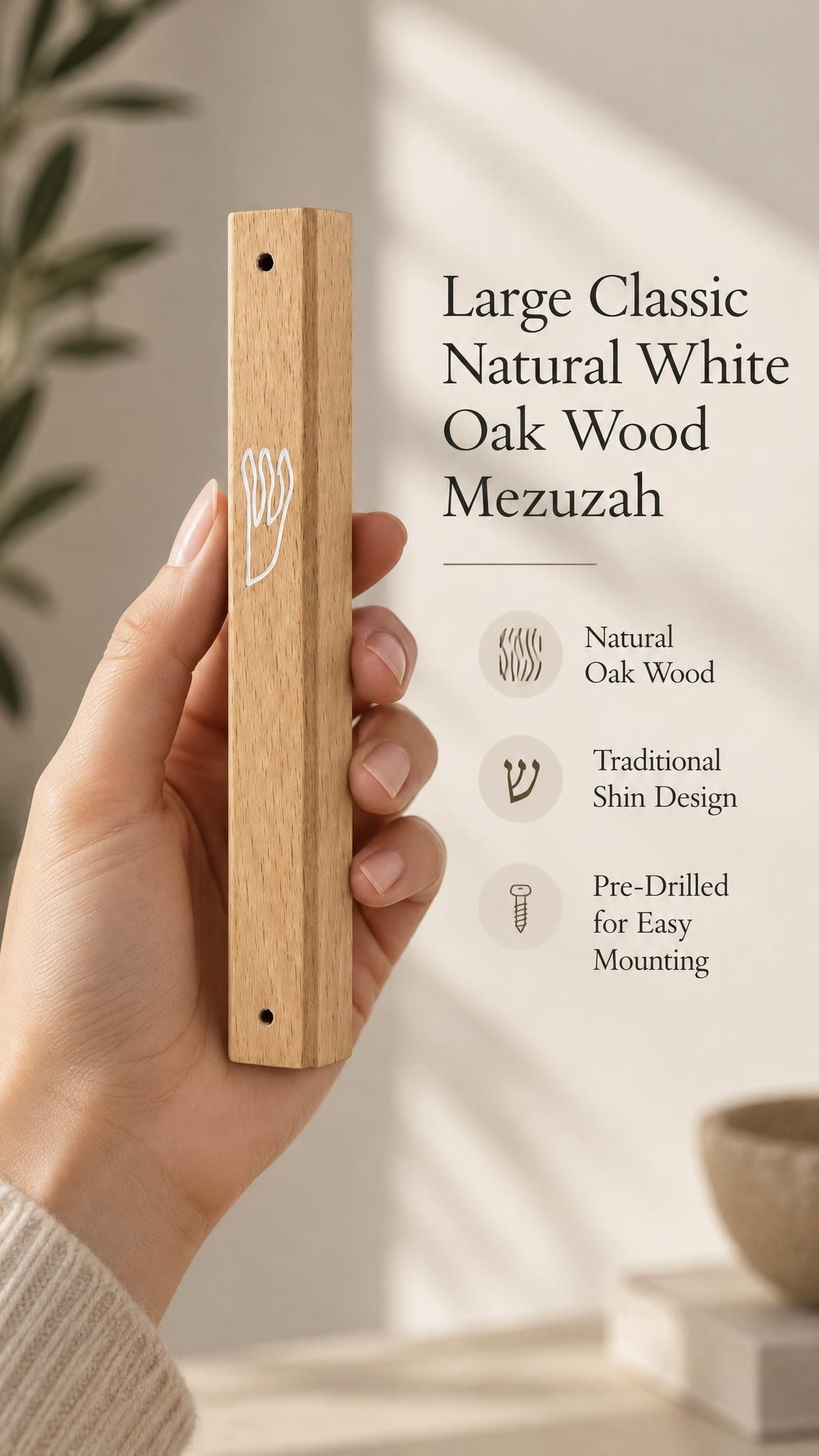 Large Classic Natural White Oak Wood Mezuzah cover held in one hand to show its long honey beige wooden body, natural grain, white outline Shin and mounting holes, with product lettering describing the traditional Hebrew design and easy mounting