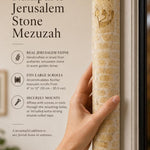 Person holding the large Jerusalem stone mezuzah with natural light and editorial typography in a balanced, premium 9:16 layout.