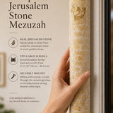 Person holding the large Jerusalem stone mezuzah with natural light and editorial typography in a balanced, premium 9:16 layout.