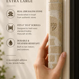 Kotel cream Jerusalem stone mezuzah mounted on a doorpost, showing natural veining across the coursed stone face.