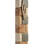 High-resolution image of large Jerusalem stone mezuzah with detailed surface textures, engraved Hebrew letters, and decorative motifs on a white background with subtle reflection.