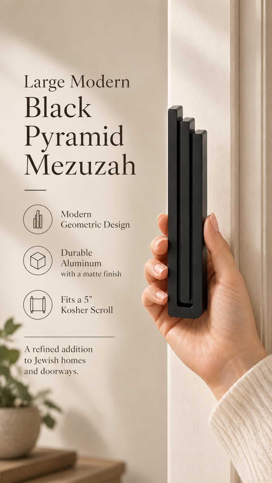 Hand holding the Large Modern Black Pyramid Mezuzah upright, revealing its deep matte black aluminum mezuzah cover, slender three-bar Pyramid design and graduated top beside illustrated product features for contemporary Jewish home Judaica