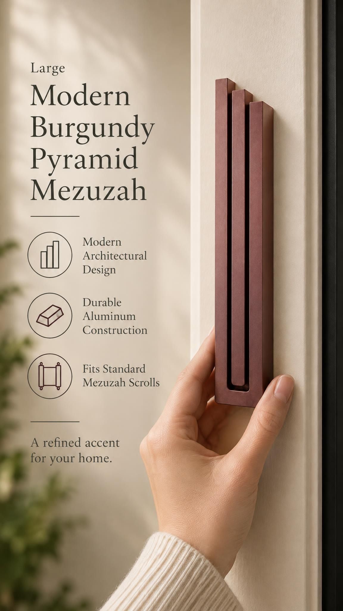 Large Modern Burgundy Pyramid Mezuzah held beside a doorpost, with the muted burgundy wine-red aluminum mezuzah cover shown close enough to reveal its three stepped bars and rounded lower edge alongside product-name and design callouts for this contemporary Judaica piece