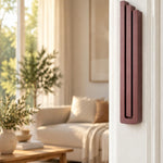 Large Modern Burgundy Pyramid Mezuzah mounted vertically on a white interior doorpost, where its muted burgundy wine-red aluminum mezuzah cover and three graduated bars create a contemporary Judaica accent with clean geometric lines against the pale doorframe