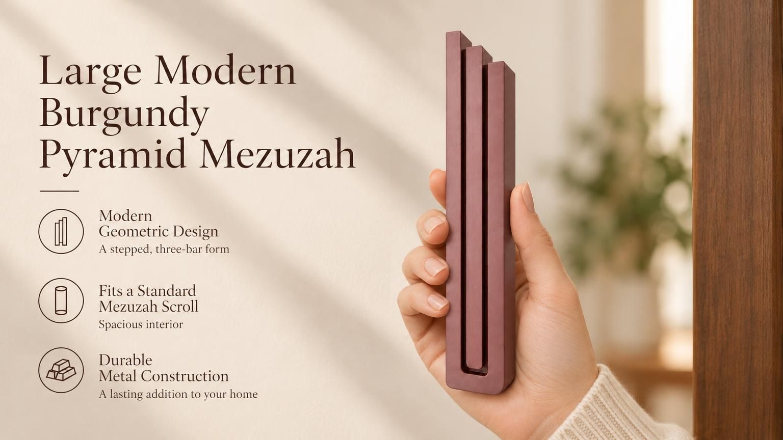 Large Modern Burgundy Pyramid Mezuzah pictured in hand as a muted burgundy wine-red aluminum mezuzah cover with three graduated bars and a contemporary stepped design, alongside its name and illustrated product features in a wide social-sharing image