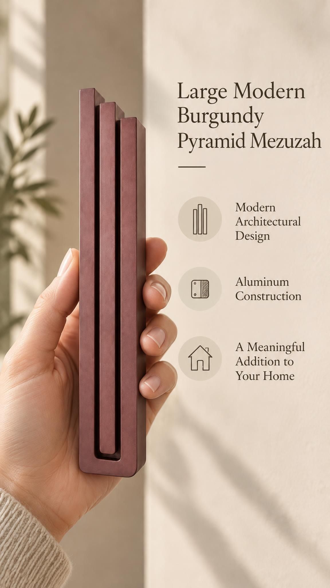 A hand presents the Large Modern Burgundy Pyramid Mezuzah with its muted burgundy wine-red aluminum mezuzah cover facing forward, highlighting the clean graduated bars and geometric vertical profile beside design illustrations for a contemporary Jewish doorway accent
