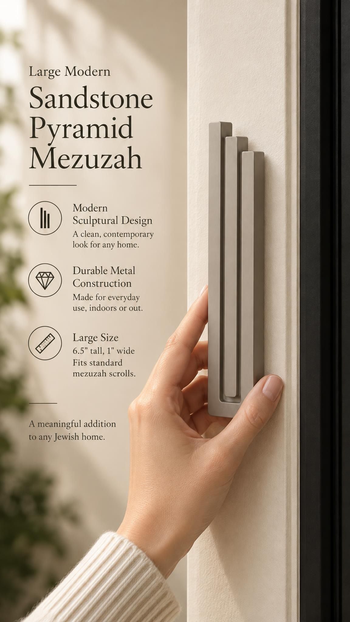 Large Modern Sandstone Pyramid Mezuzah held beside a doorpost, with the warm taupe sandstone aluminum mezuzah cover shown close enough to reveal its three stepped bars and rounded lower edge alongside product-name and design callouts for this contemporary Judaica piece