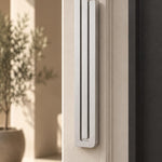 Large Modern Silver Pyramid Mezuzah mounted on a pale doorpost beside its product name and illustrated design features, showing the softly brushed silver aluminum mezuzah cover and three stepped bars as a contemporary detail for a Jewish home entrance