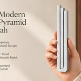 Large Modern Silver Pyramid Mezuzah pictured in hand as a softly brushed silver aluminum mezuzah cover with three graduated bars and a contemporary stepped design, alongside its name and illustrated product features in a wide social-sharing image