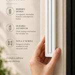 Large Modern White Pyramid Mezuzah held beside a doorpost, with the smooth matte white aluminum mezuzah cover shown close enough to reveal its three stepped bars and rounded lower edge alongside product-name and design callouts for this minimalist Judaica piece
