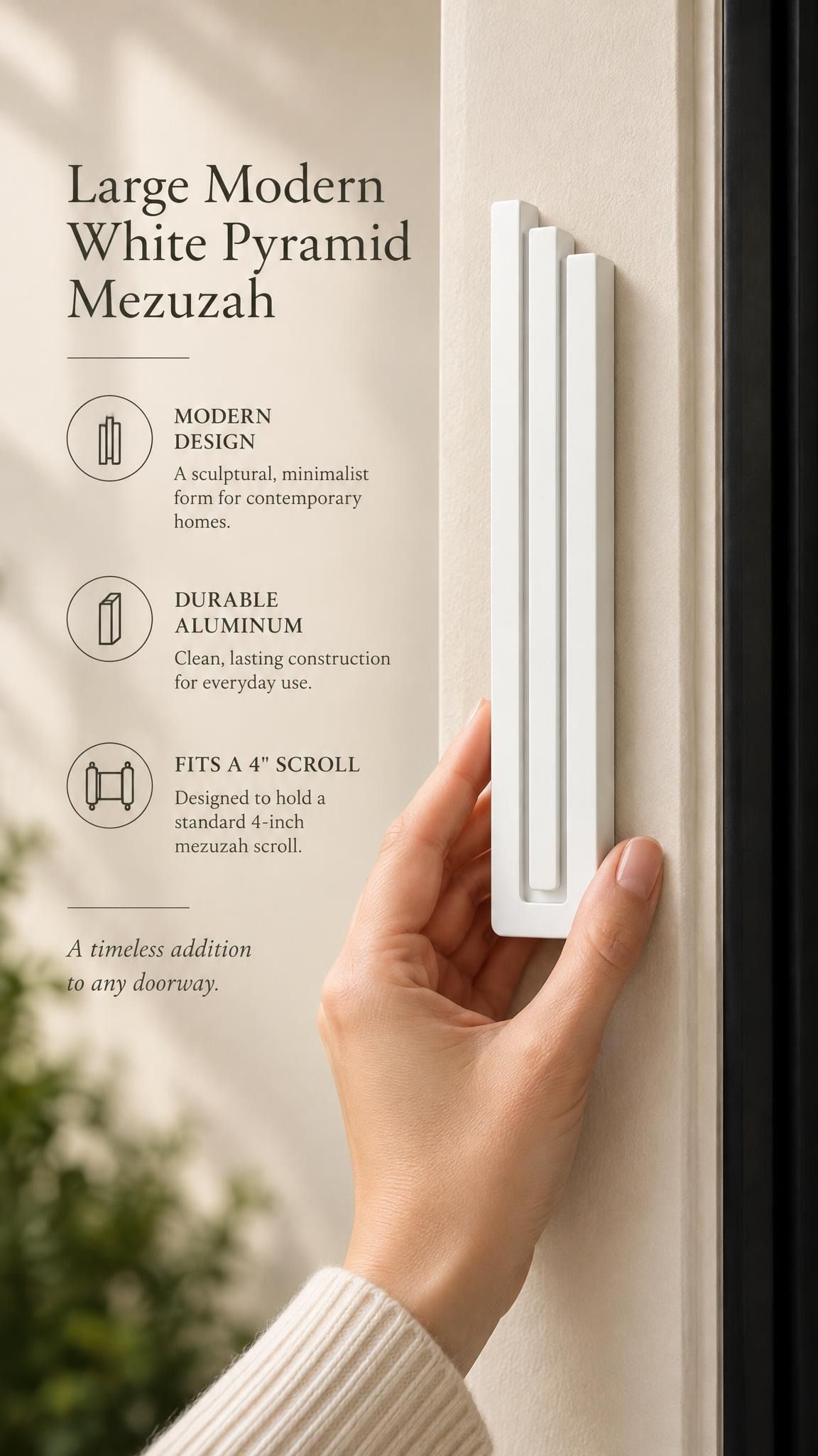 Large Modern White Pyramid Mezuzah held beside a doorpost, with the smooth matte white aluminum mezuzah cover shown close enough to reveal its three stepped bars and rounded lower edge alongside product-name and design callouts for this minimalist Judaica piece