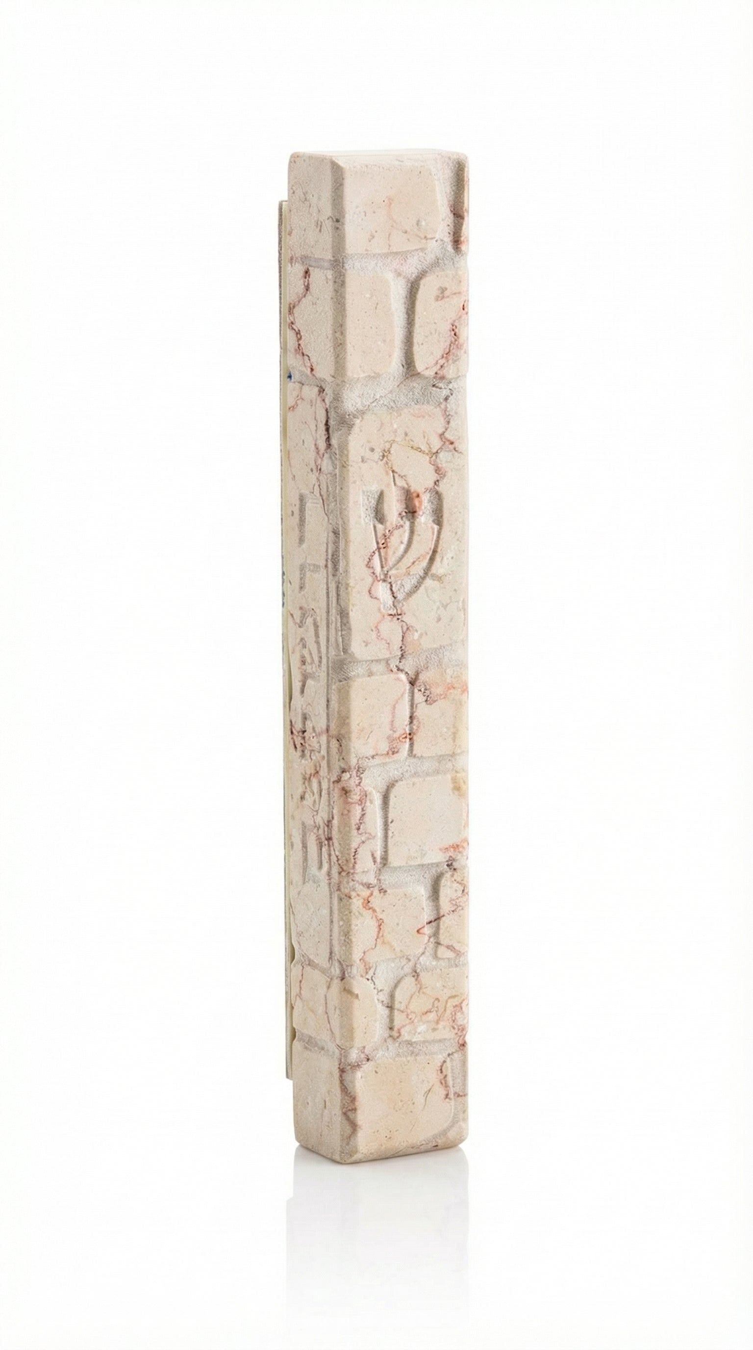 large white Jerusalem stone mezuzah made in Israel, carved with Kotel wall blocks, natural cream and rose veining, and a subtle Hebrew Shin