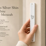 Person holding a large white acrylic mezuzah case featuring a crowned silver Shin Hebrew letter for doorpost mounting.