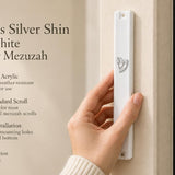 Person holding a large white acrylic mezuzah case featuring a crowned silver Shin Hebrew letter for doorpost mounting.