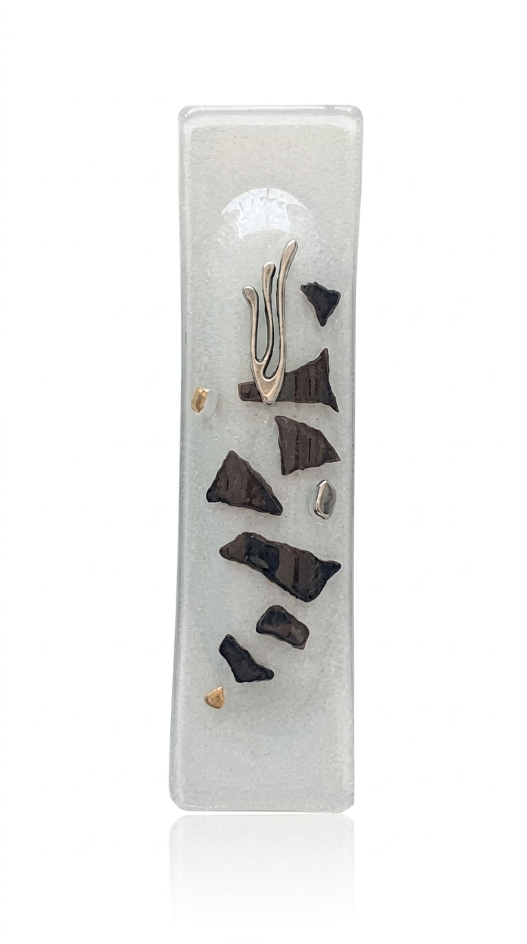 Elegant glass mezuzah with Hebrew inscriptions, designed for home doorways, displayed on a bright white studio background with soft reflection.