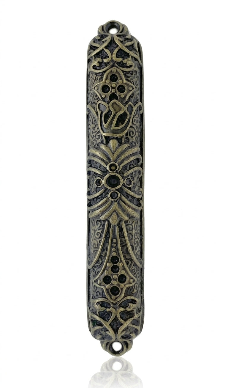 Upscale Levi Mezuzah made of brass, 4 inches tall, with detailed engraved Hebrew lettering and decorative motifs, placed on a white studio background with soft reflection.