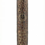 Upscale brass mezuzah with detailed engraved Hebrew letters and decorative motifs, displayed on a clean white background with subtle reflection.