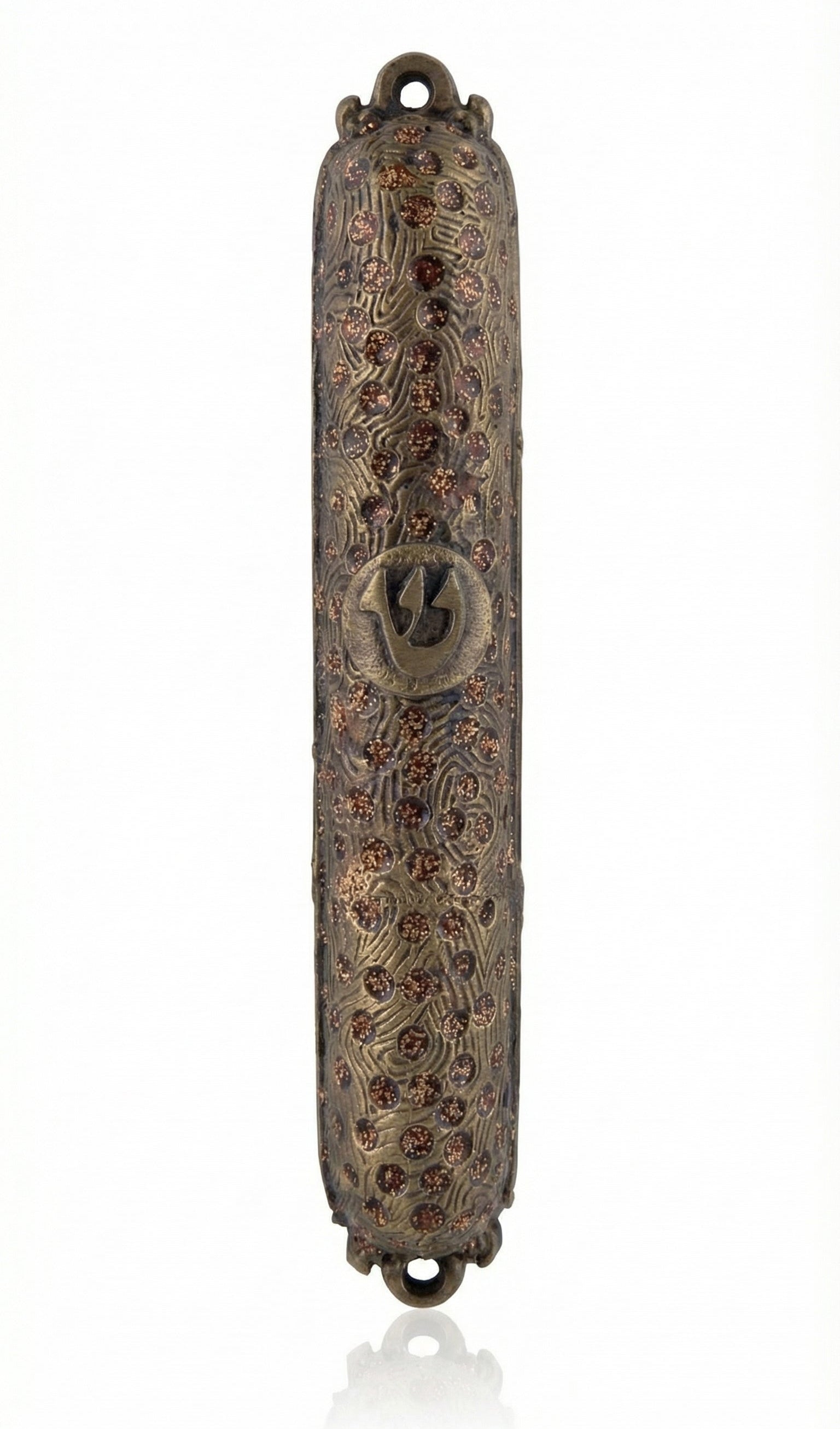 Upscale brass mezuzah with detailed engraved Hebrew letters and decorative motifs, displayed on a clean white background with subtle reflection.