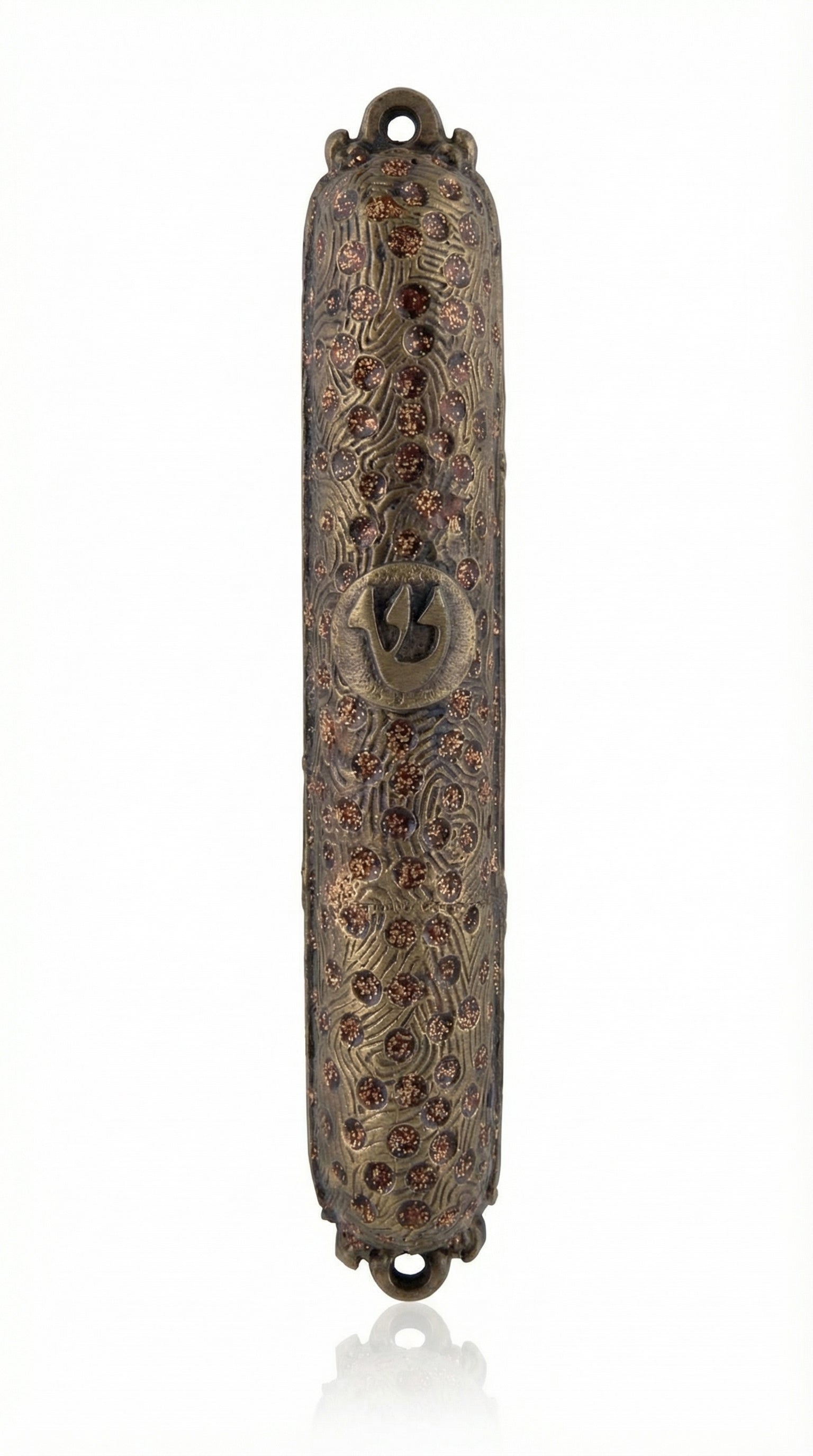 Upscale brass mezuzah with detailed engraved Hebrew letters and decorative motifs, displayed on a clean white background with subtle reflection.
