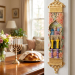 Elegant golden Shabbat candlelight mezuzah with floral details, ornate gold trim, placed on a Jewish interior doorway for a warm, traditional look.