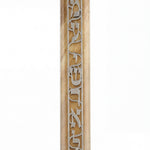 Close-up of acrylic Shema Mezuzah on white background with reflection, highlighting intricate details and craftsmanship.