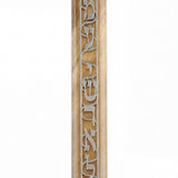 Close-up of acrylic Shema Mezuzah on white background with reflection, highlighting intricate details and craftsmanship.