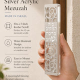 Person holding the Blessings of Peace Silver Acrylic Mezuzah in a balanced, stylish composition for product promotion, with clear visibility of the product.