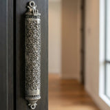 Contemporary interior scene with the mezuzah attached to a sleek, modern door in a softly lit hallway