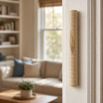 Jerusalem stone mezuzah mounted on residential doorpost, demonstrating placement and scale in home setting.