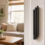 Black aluminum Midnight Black Cascade Mezuzah mounted on a residential doorpost in natural indoor lighting.