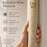 Hand displaying the Jerusalem stone mezuzah with warm natural lighting, refined typography, and generous space for editing in a 9:16 composition.