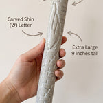 Person holding Jerusalem stone mezuzah, showcasing material and design details.