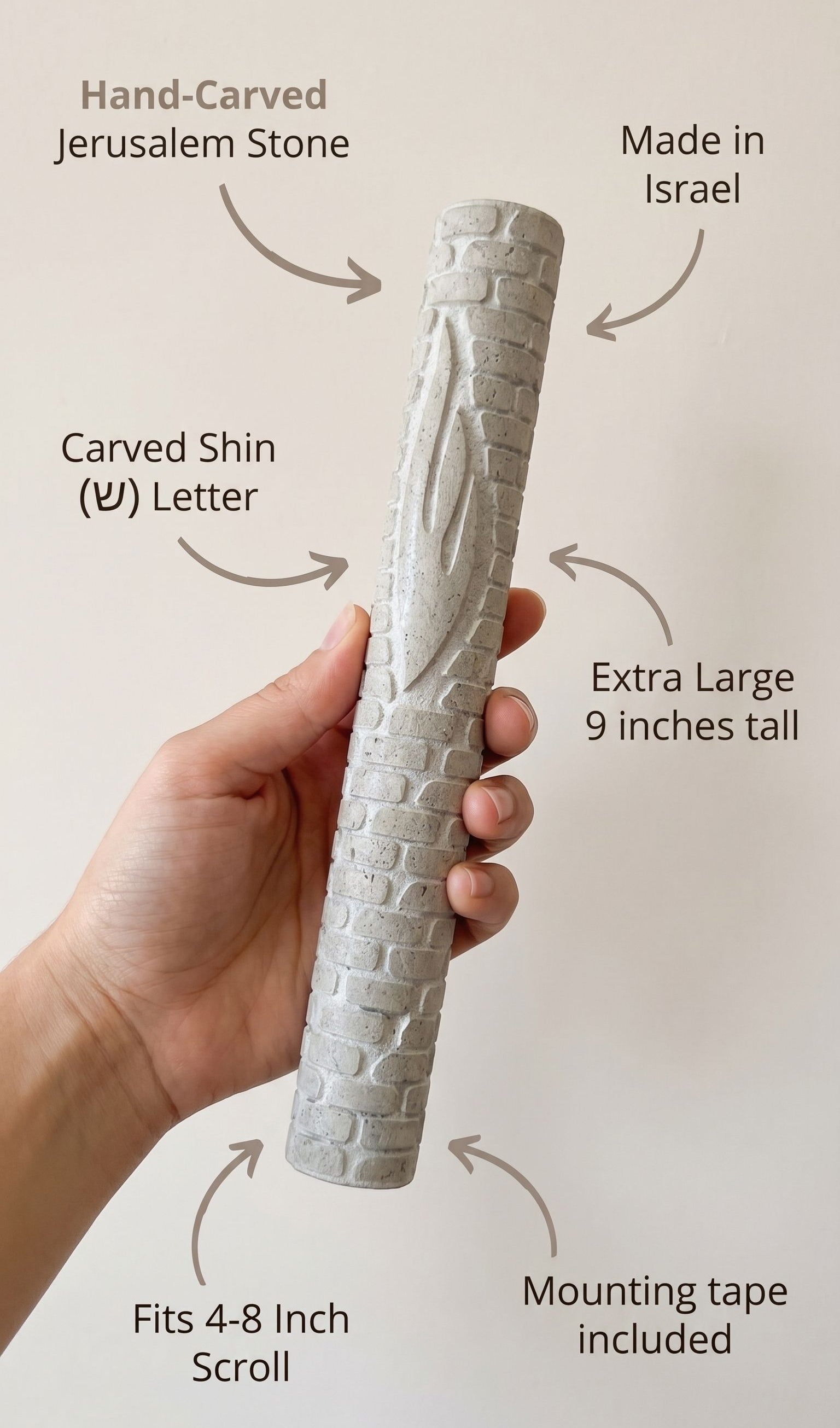 Person holding Jerusalem stone mezuzah, showcasing material and design details.