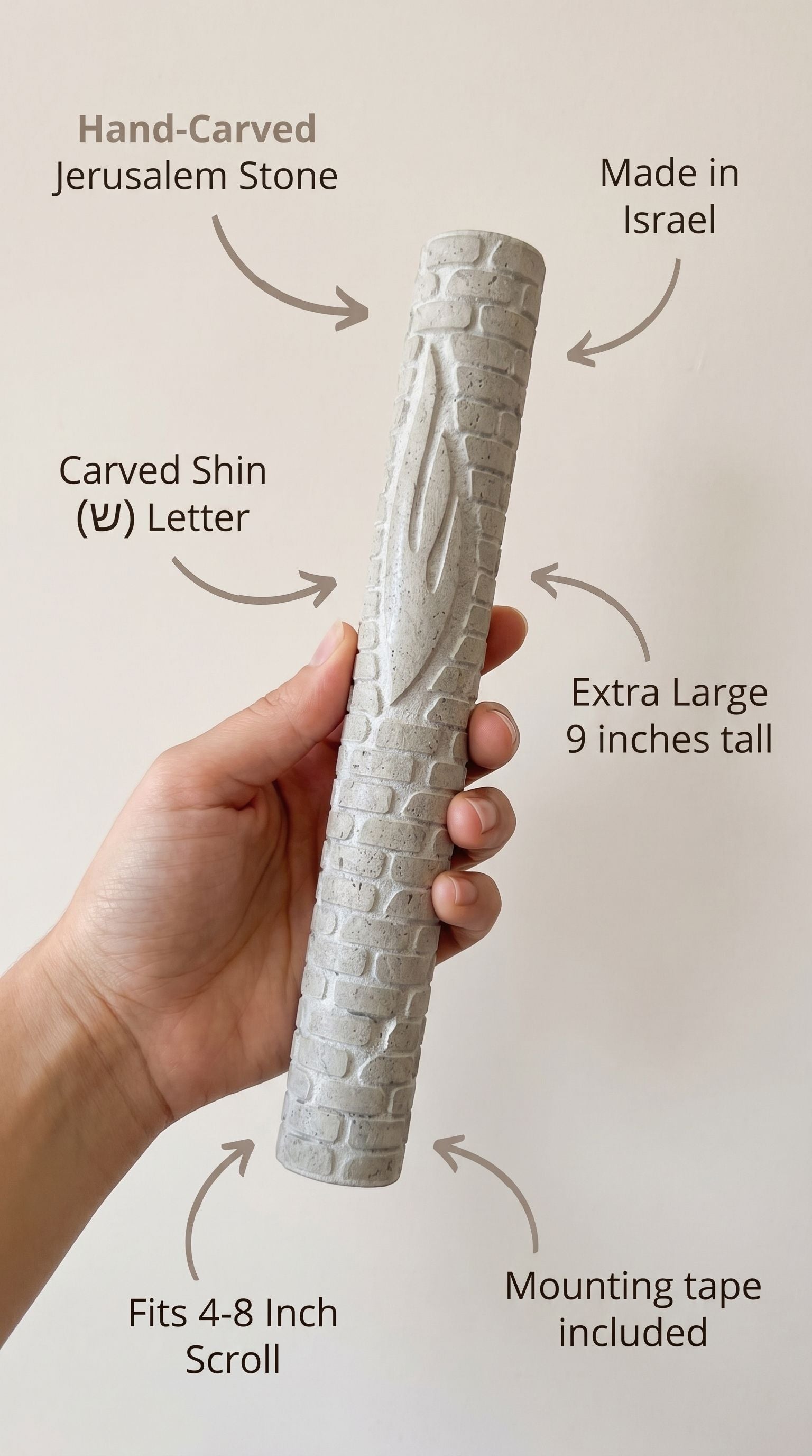 Person holding Jerusalem stone mezuzah, showcasing material and design details.