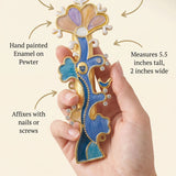 Person holding the enamel Tree of Life Mezuzah with focus on product details, material and design for promotional use