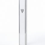 Lumen Silver-Framed White Acrylic Mezuzah standing upright with a narrow silver-toned frame around the smooth white front and a matching Hebrew silver Shin
