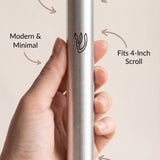 Person holding the modern silver mezuzah, minimalist composition highlighting material and subtle design features.