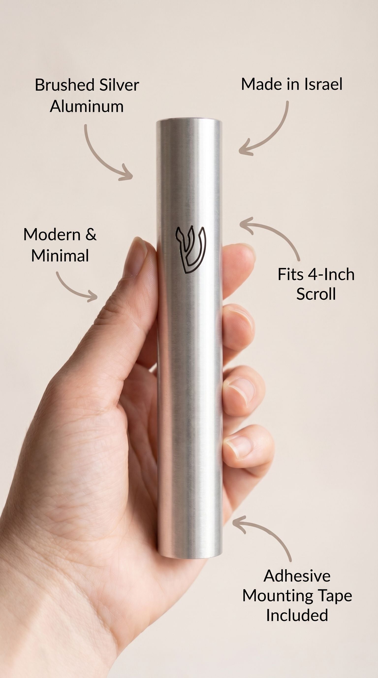 Person holding the modern silver mezuzah, minimalist composition highlighting material and subtle design features.