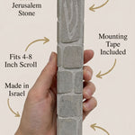 Clean callout image of a person holding the Jerusalem stone mezuzah, showcasing material and craftsmanship subtly and stylishly.